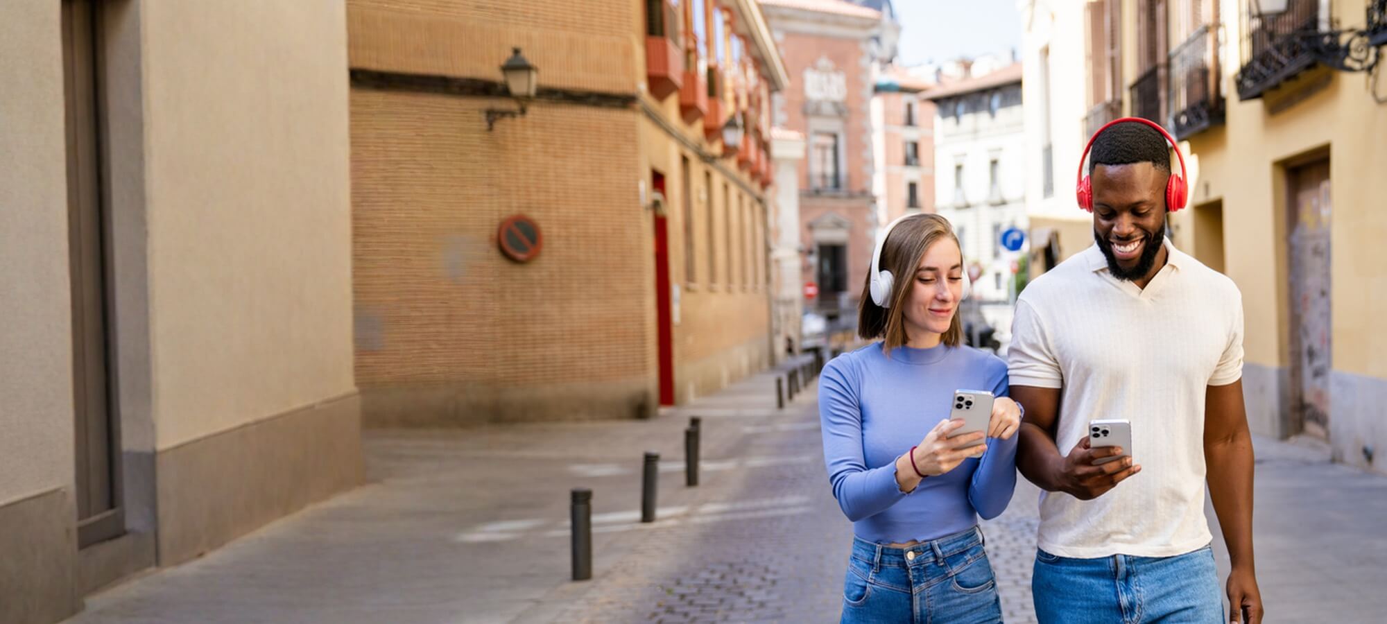 Hero banner for Mobileciti case study featuring a happy couple wearing headphones and looking at mobile phones, highlighting the transformation into a faster, more resilient online store built for performance, scalability, and customer confidence