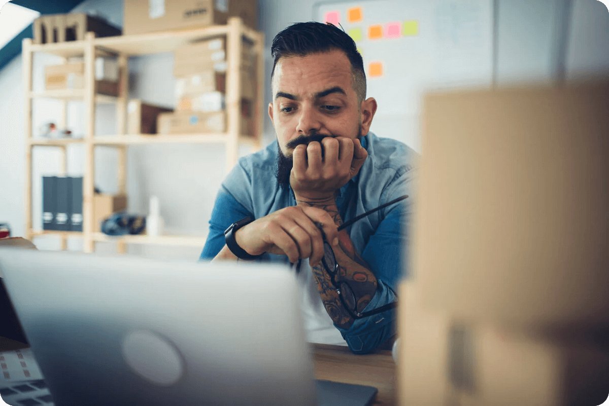 Business owner reviewing a Shopify website design on a laptop