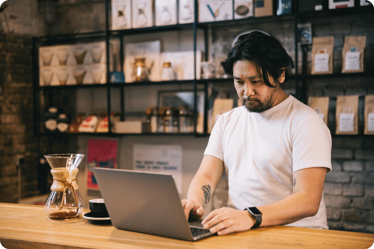 Frustrated business owner with outdated Shopify store, representing poor mobile experience, slow load times, and lost sales opportunities